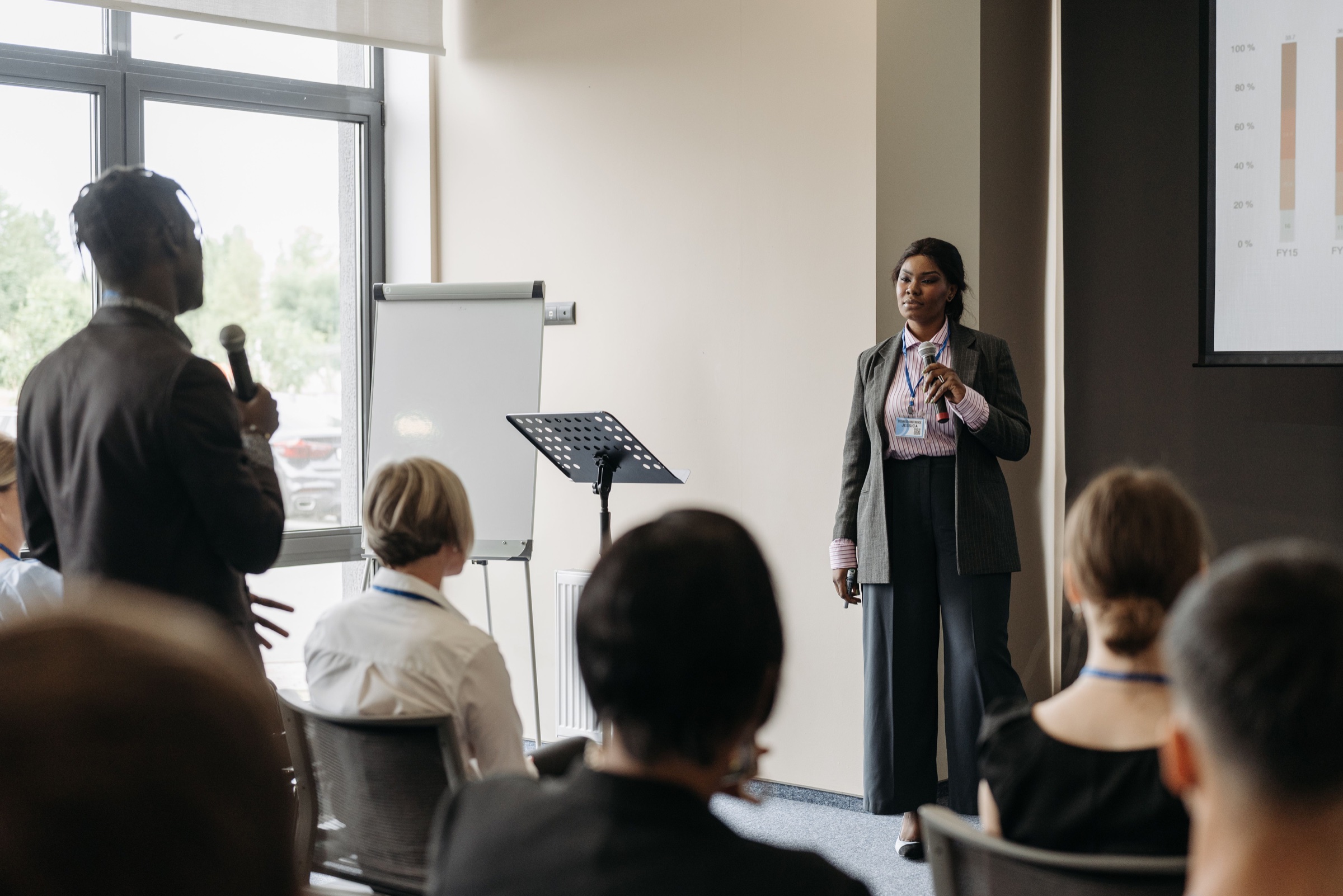 Woman speaking to an audience in a leadership setting.
