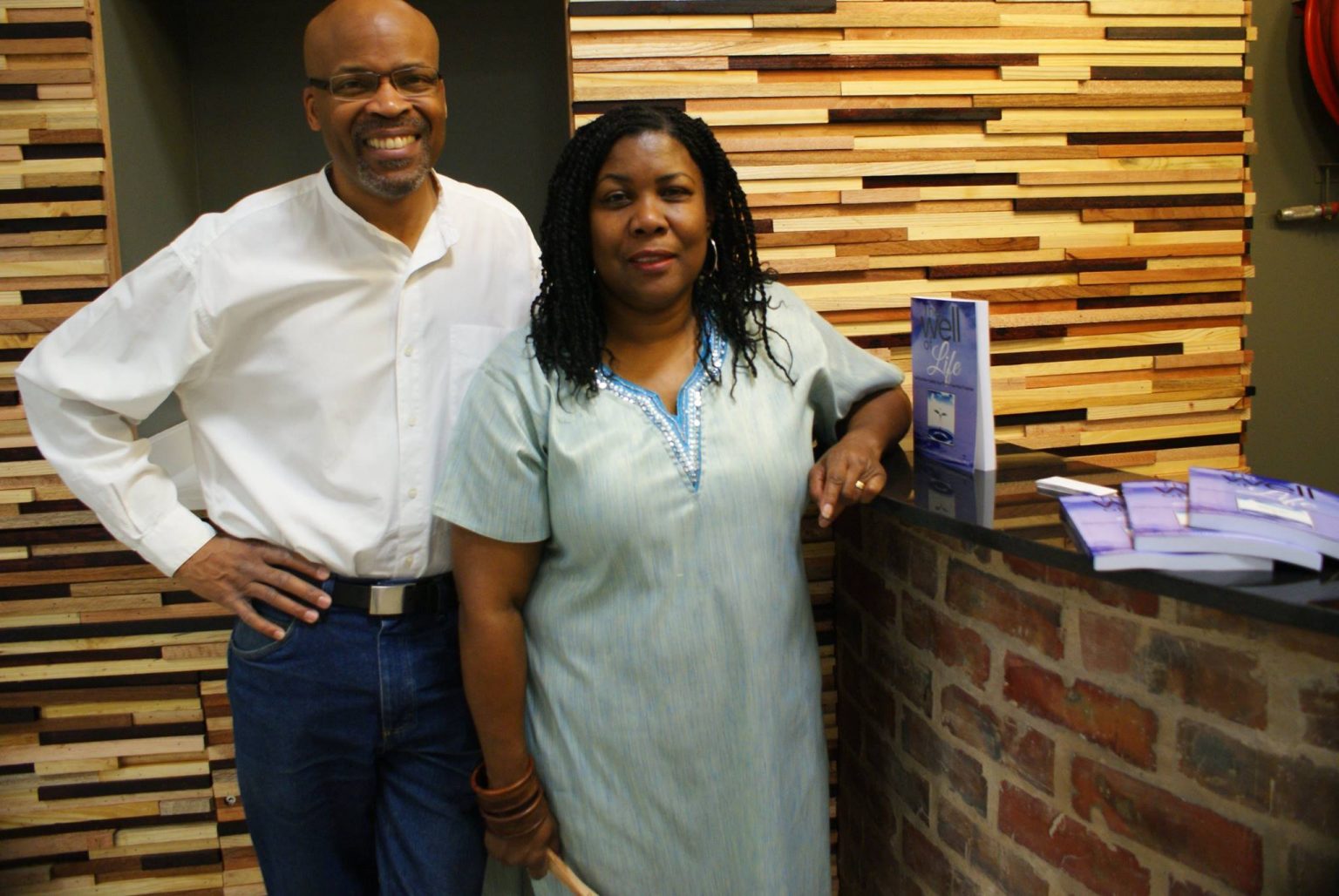 Authors standing beside a display of books.